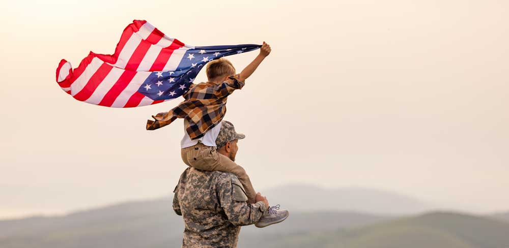 Soldier with child and American Flag